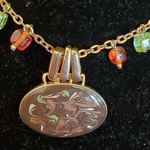 Brown, green swirled pendant on goldtone chain